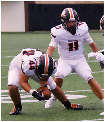 A group of football players celebrating a touchdown. Description generated by AI