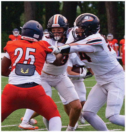 A football player wearing a blue and red jersey. Description generated by AI