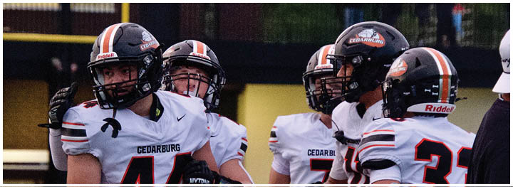 A group of football players on a field. Description generated by AI