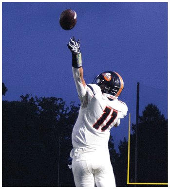 A group of football players celebrating a touchdown. Description generated by AI