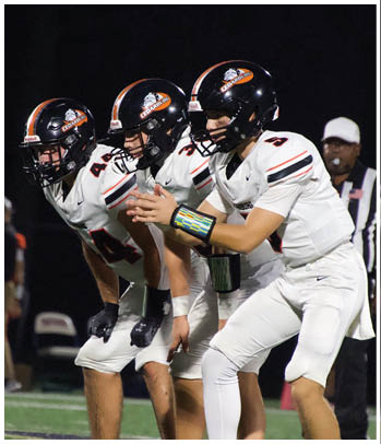 A group of football players celebrating a touchdown. Description generated by AI