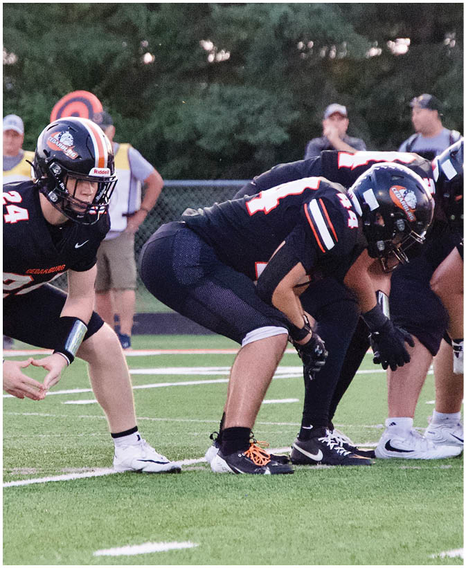 A group of football players on a field. Description generated by AI