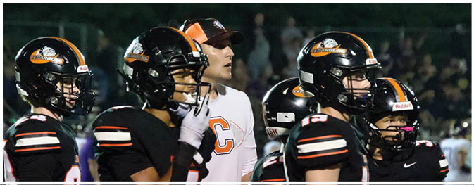 A group of football players on a field. Description generated by AI