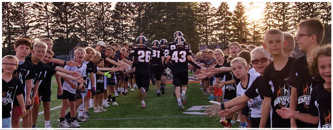 A group of football players on a field. Description generated by AI