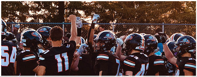 A group of football players on a field. Description generated by AI