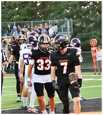 A group of football players celebrating a touchdown. Description generated by AI