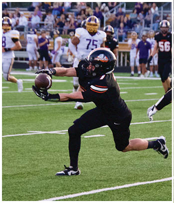 A group of football players celebrating a touchdown. Description generated by AI