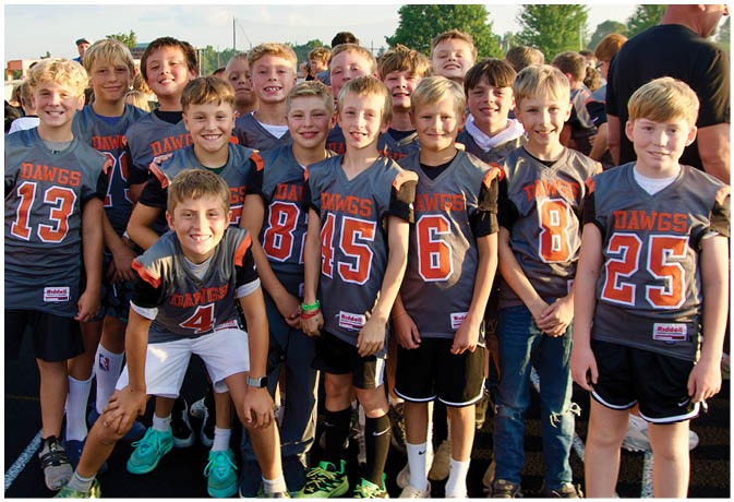 A group of football players on a field. Description generated by AI