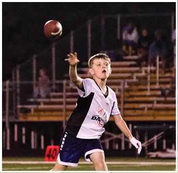 A group of football players celebrating a touchdown. Description generated by AI