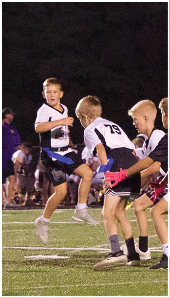 A group of football players celebrating a touchdown. Description generated by AI