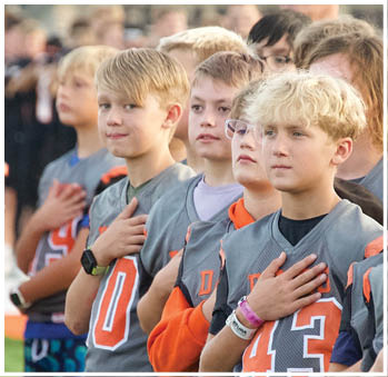 A group of football players celebrating a touchdown. Description generated by AI