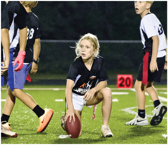 A group of football players on a field. Description generated by AI