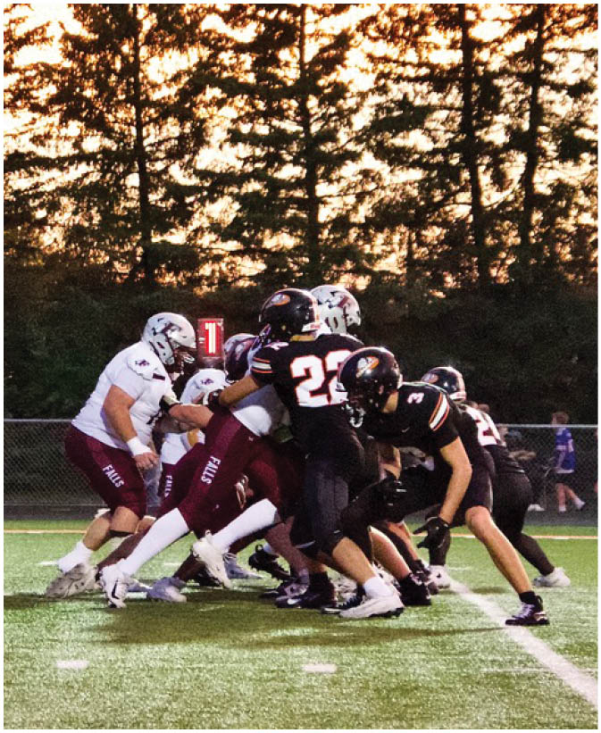 A group of football players on a field. Description generated by AI