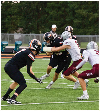A group of football players celebrating a touchdown. Description generated by AI