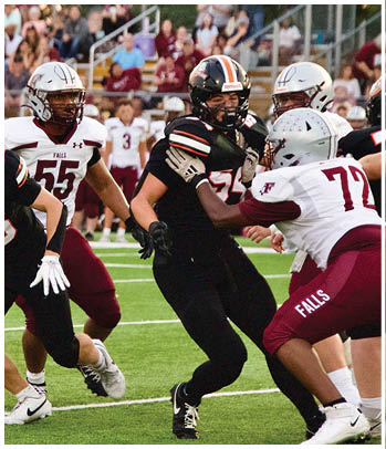 A group of football players celebrating a touchdown. Description generated by AI