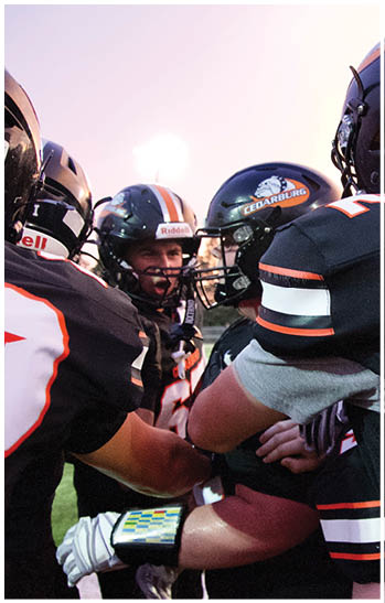 A group of football players celebrating a touchdown. Description generated by AI
