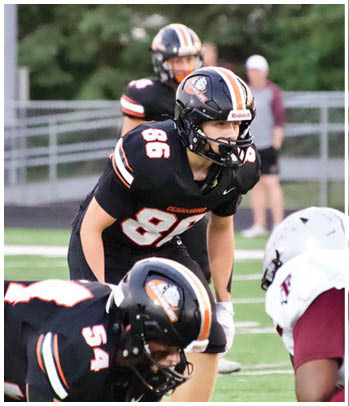 A group of football players celebrating a touchdown. Description generated by AI