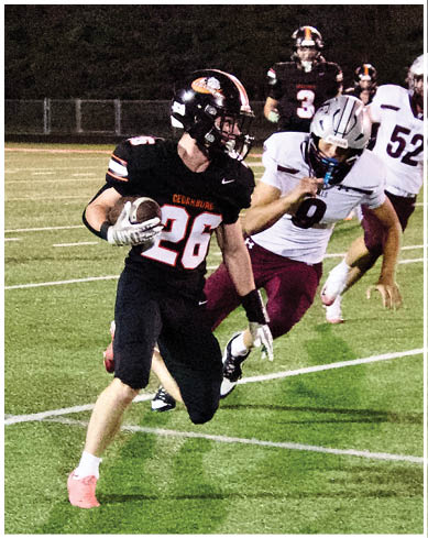 A football player wearing a blue and red jersey. Description generated by AI
