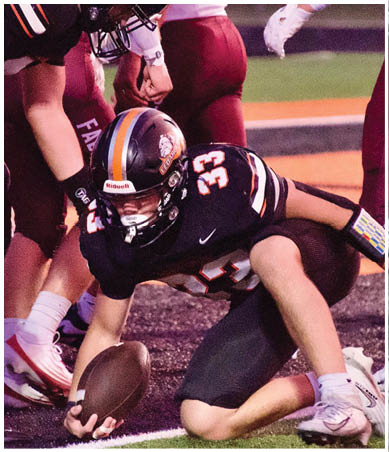 A football player wearing a blue and red jersey. Description generated by AI