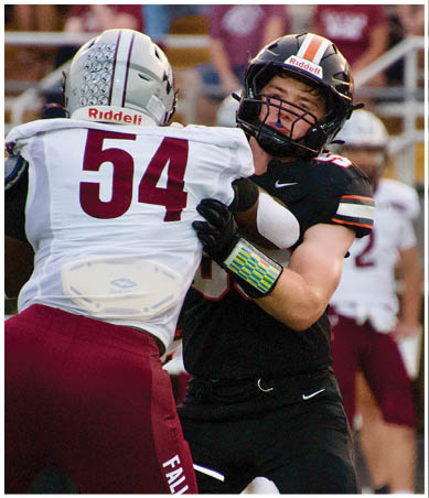 A football player wearing a blue and red jersey. Description generated by AI