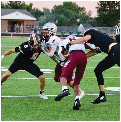 A football game is taking place with a group of men on the field. Description generated by AI