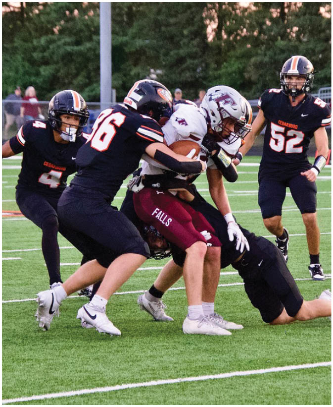 A group of football players on a field. Description generated by AI