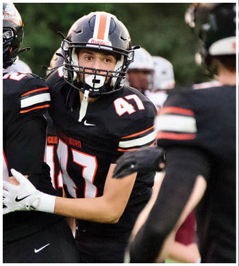 A group of football players celebrating a touchdown. Description generated by AI