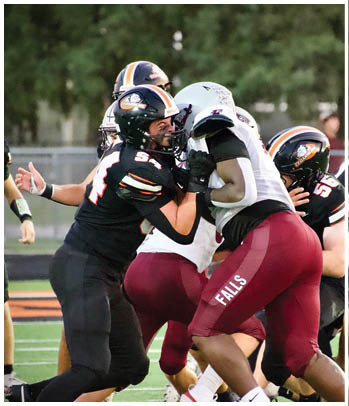 A group of football players celebrating a touchdown. Description generated by AI