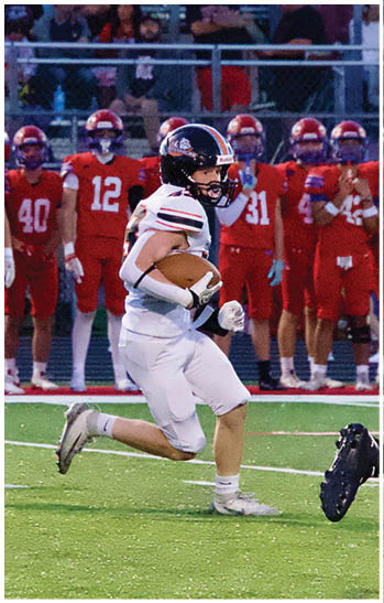 A group of football players celebrating a touchdown. Description generated by AI