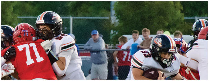 A group of football players on a field. Description generated by AI
