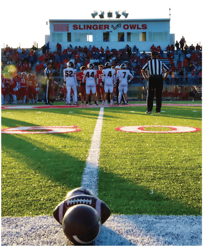 A group of football players on a field. Description generated by AI
