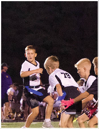 A group of football players celebrating a touchdown. Description generated by AI