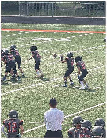 A group of football players celebrating a touchdown. Description generated by AI