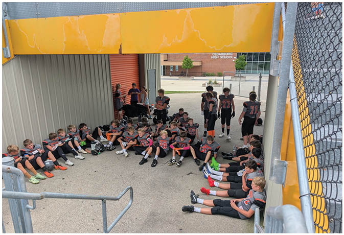 A group of football players on a field. Description generated by AI