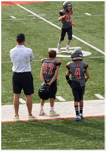 A group of football players celebrating a touchdown. Description generated by AI