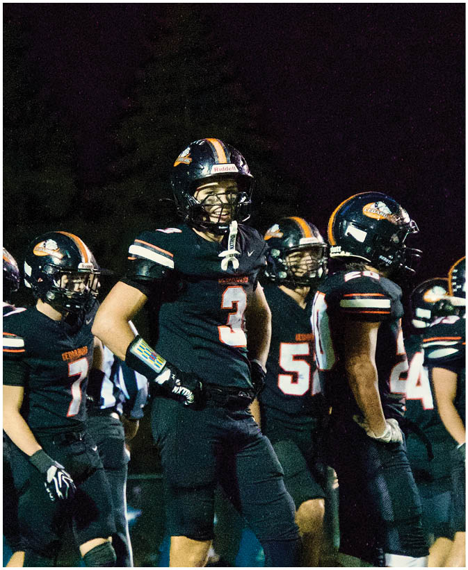 A group of football players on a field. Description generated by AI