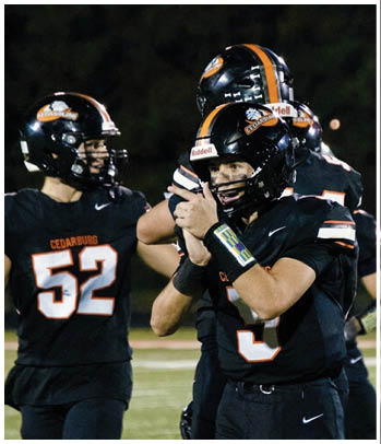 A group of football players celebrating a touchdown. Description generated by AI