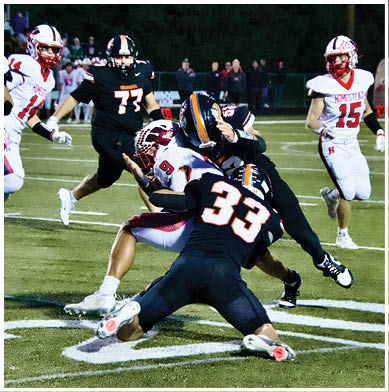 A football game is taking place with a group of men on the field. Description generated by AI
