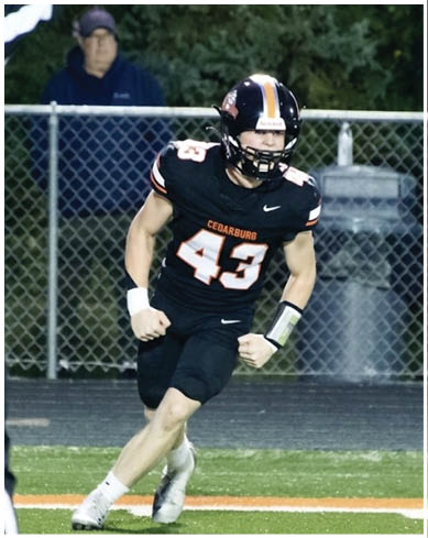 A football player wearing a blue and red jersey. Description generated by AI