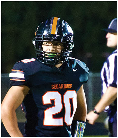 A football player wearing a blue and red jersey. Description generated by AI