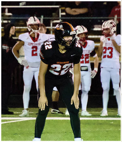 A football player wearing a blue and red jersey. Description generated by AI