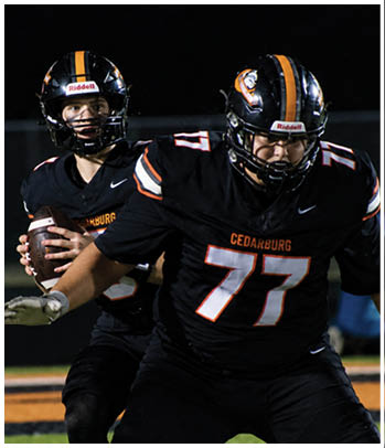 A group of football players celebrating a touchdown. Description generated by AI