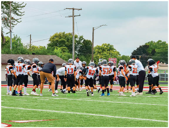 A group of football players on a field. Description generated by AI
