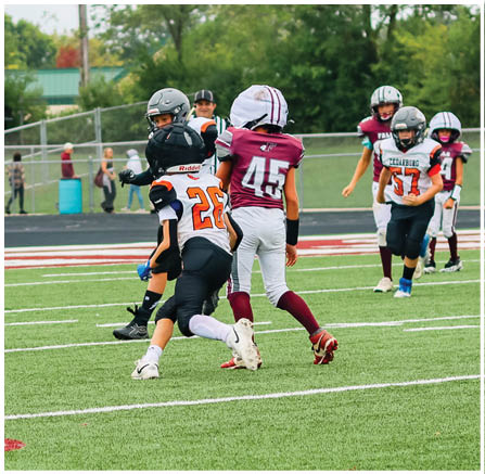 A group of football players celebrating a touchdown. Description generated by AI