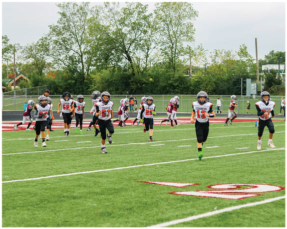 A group of football players on a field. Description generated by AI