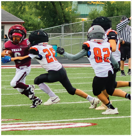 A group of football players celebrating a touchdown. Description generated by AI