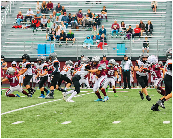 A group of football players on a field. Description generated by AI