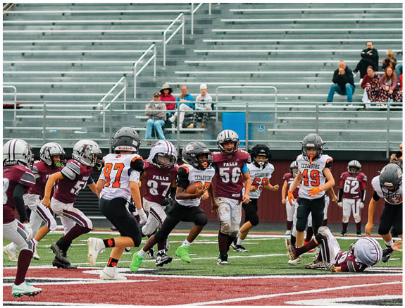 A group of football players on a field. Description generated by AI