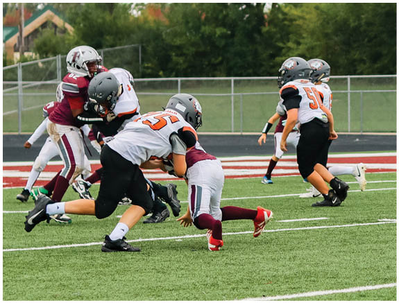 A group of football players on a field. Description generated by AI