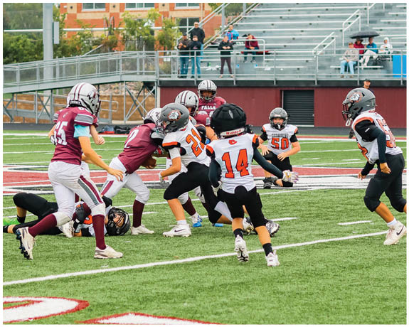 A group of football players on a field. Description generated by AI